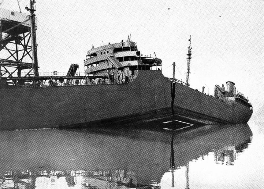 Black and white photograph depicting the SS Schenectady in the water at the Swan Island shipyards after the midships hull cracked.